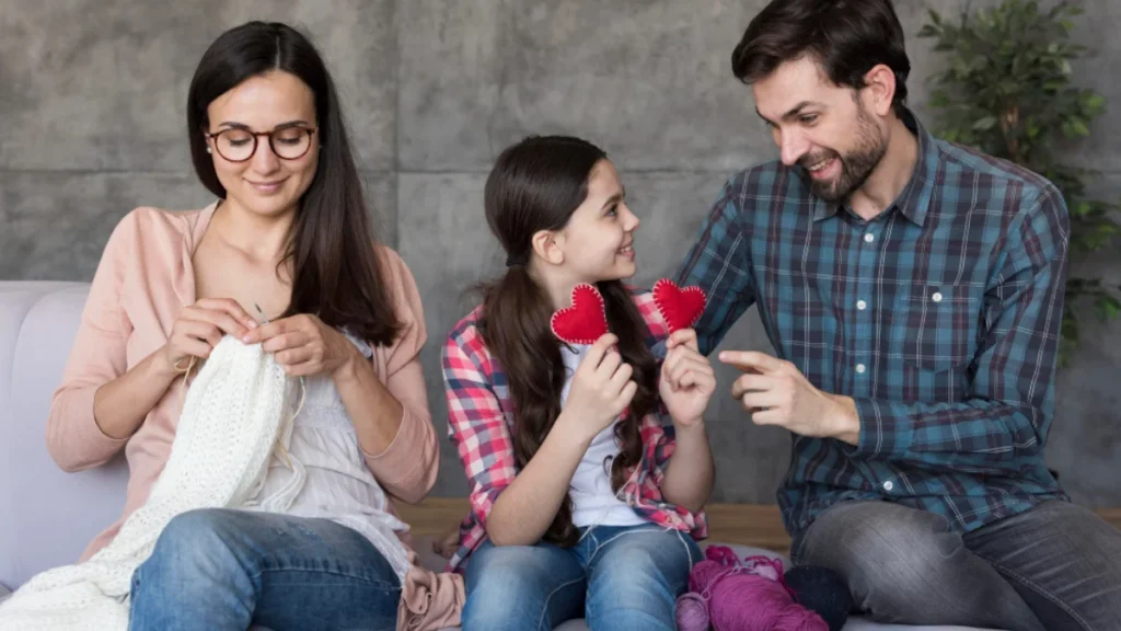 A family sits together on a couch
