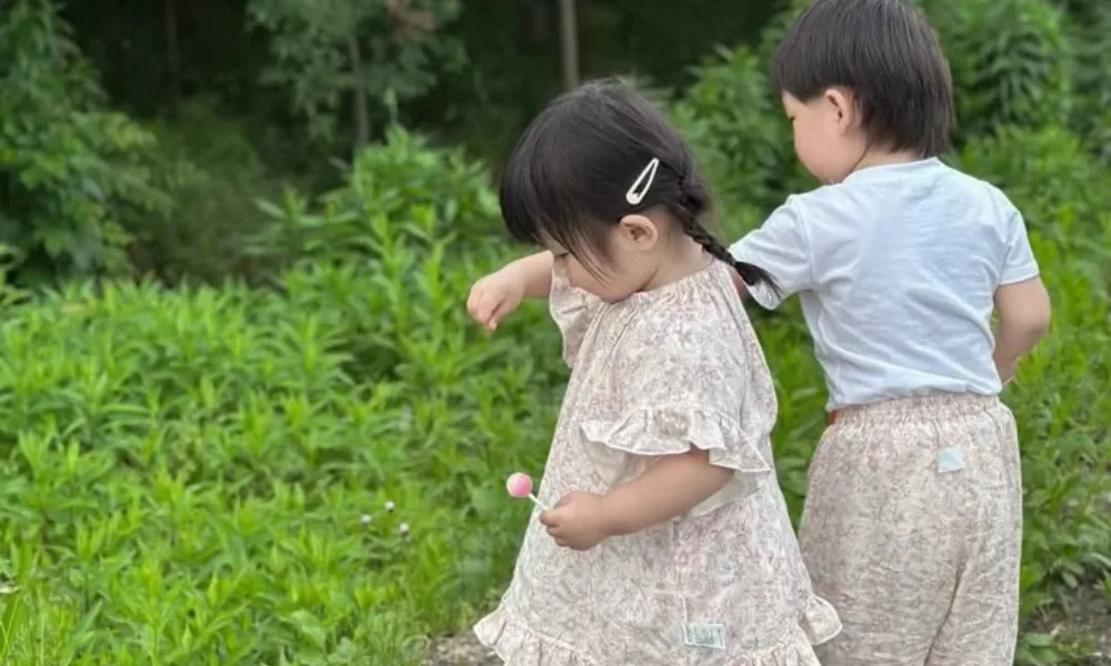 Young boy and girl playing outside, featured in an article on popular unisex names. 