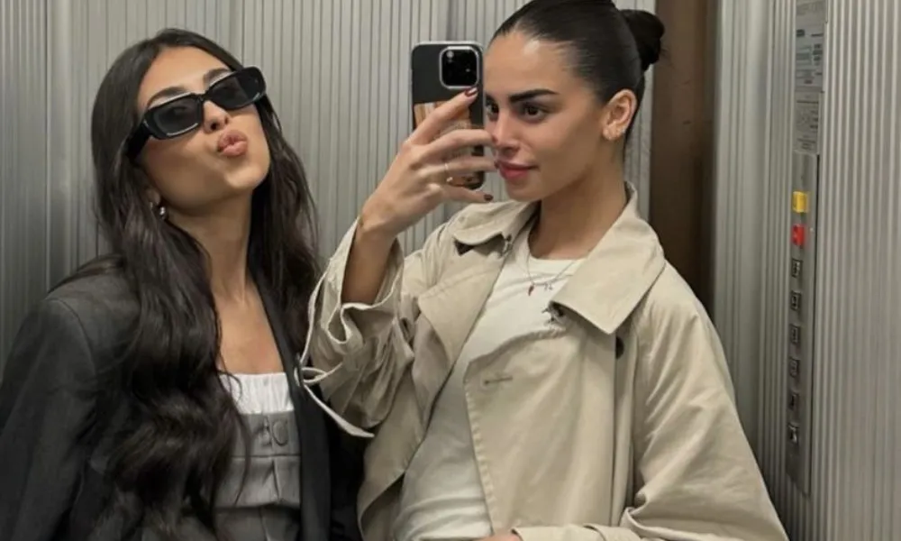 Best friends taking a mirror selfie for Funny Names for Your Bestie.
